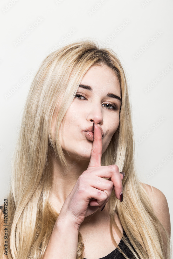 Close-up portrait of a young beautiful blonde girl on a light background. A woman with different emotions on her face. Close-up portrait of a young beautiful blonde girl on a light background. A woman with different emotions on her face.