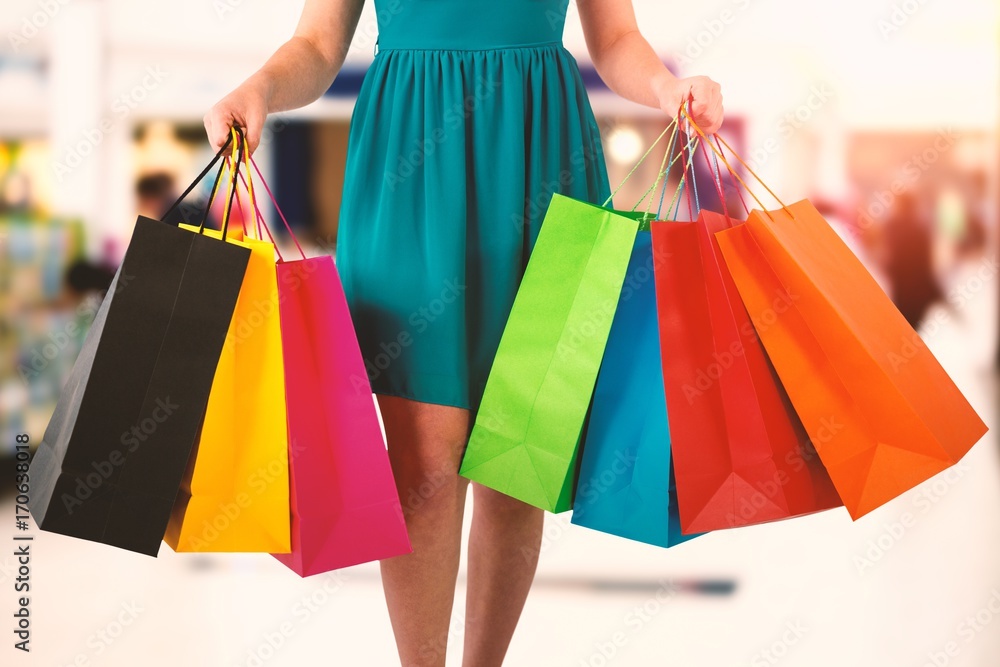 Composite image of women holding shopping bag 