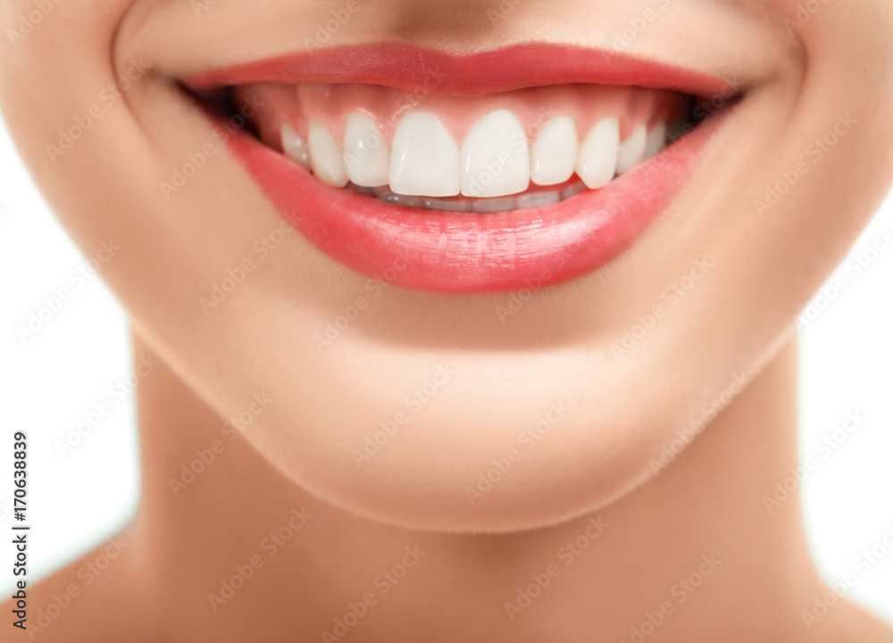 Fototapeta premium Beautiful young woman with healthy teeth on white background