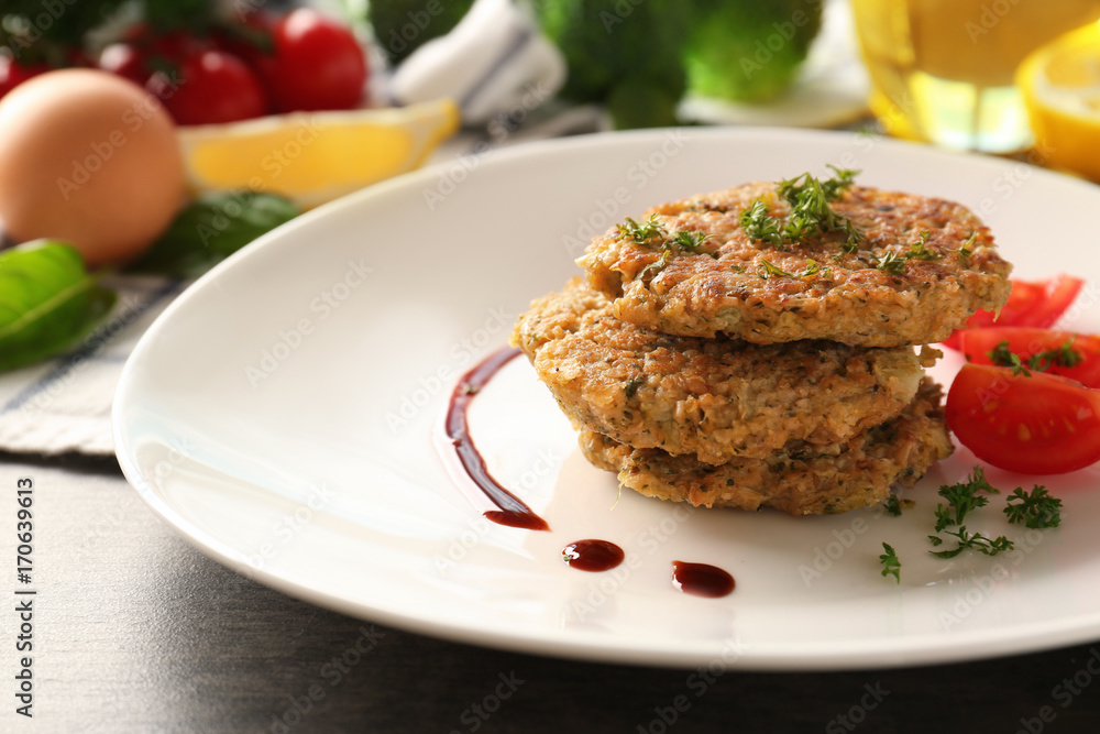 Broccoli pancakes served with cherry tomato and sauce on white plate, closeup Broccoli pancakes served with cherry tomato and sauce on white plate, closeup