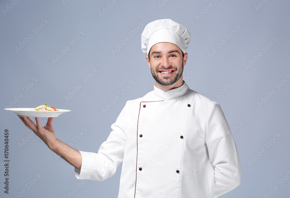 Young male chef on light background Young male chef on light background