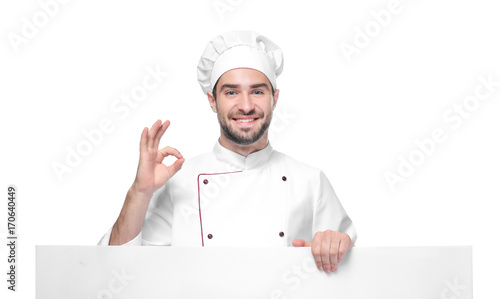 Young male chef with poster isolated on white