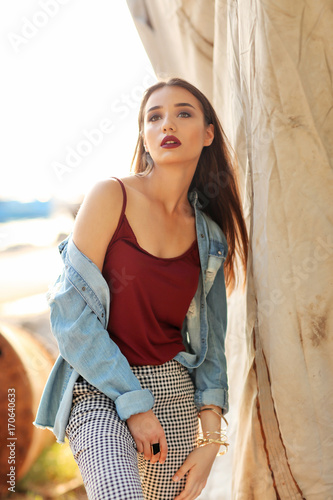 Fashionable young woman out...