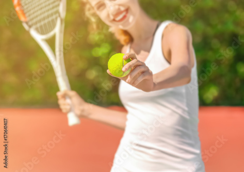 Young woman playing tennis on court