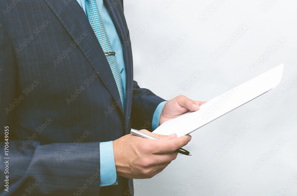 Business man reading text of agreement documents. Contract or agreement conclusion.