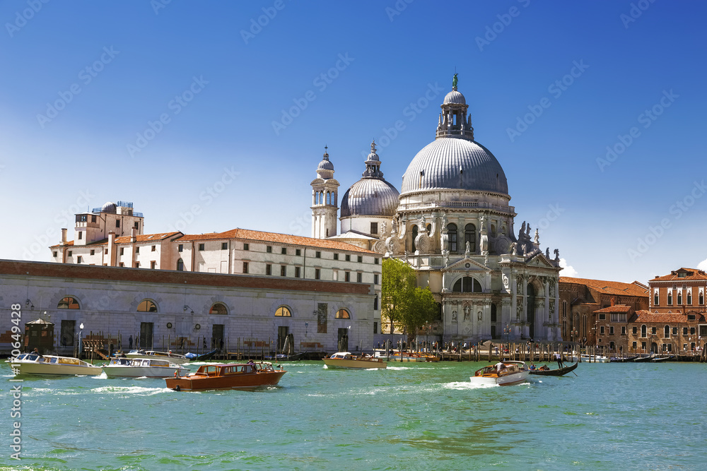 Venice, the Grand canal, the Cathedral of Santa Maria Della Salute and boats with tourists. Italy