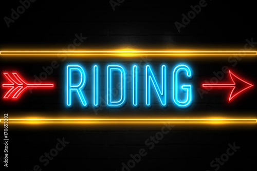 Riding - fluorescent Neon Sign on brickwall Front view