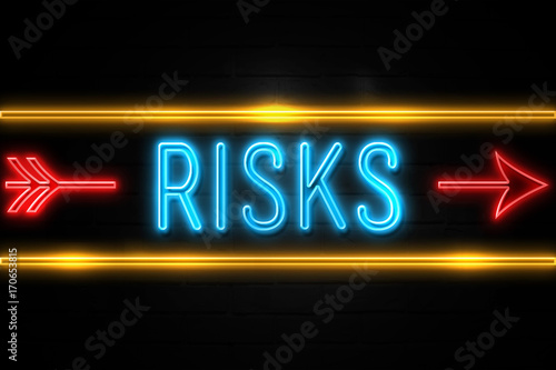 Risks - fluorescent Neon Sign on brickwall Front view