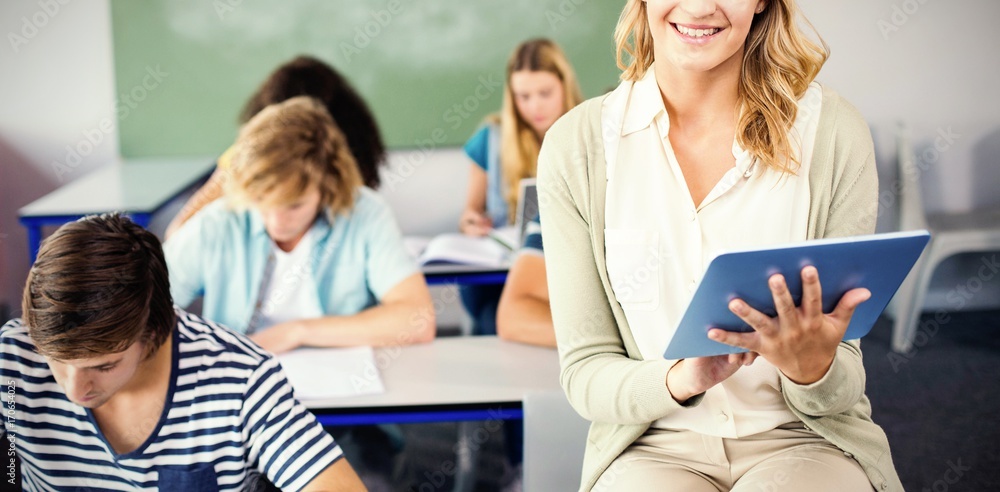 Fototapeta premium Female teacher using digital tablet in class