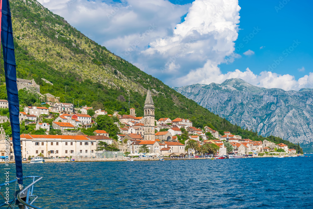 MONTENEGRO - JUNE 04/2017. Tourists sailed on the yacht past the city of Perast in the Boka Bay of Kotor.