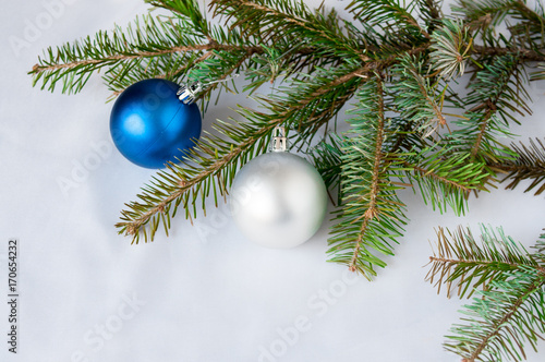 Blue and silver ball on a spruce branch