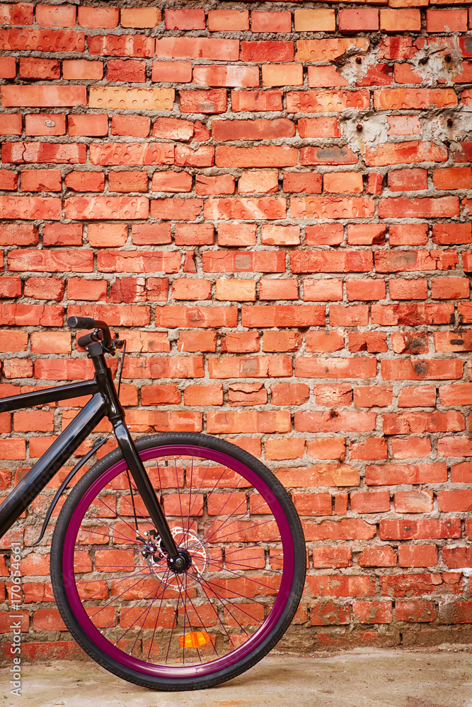 Black bike against red brick wall. Black bike against red brick wall.