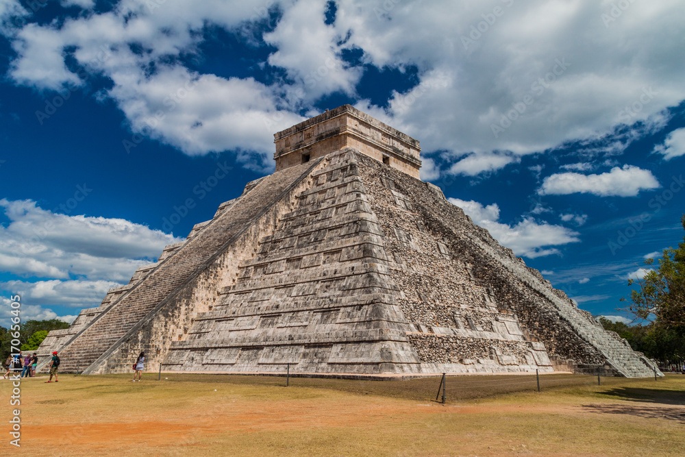 CHICHEN ITZA, MEXICO - FEB 26, 2016: Crowds of tourists visit the Kukulkan pyramid at the archeological site Chichen Itza.