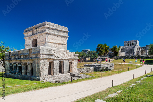 TULUM, MEXIO - FEB 29, 2016: Tourists visit the ruins of the ancient Maya city Tulum, Mexico