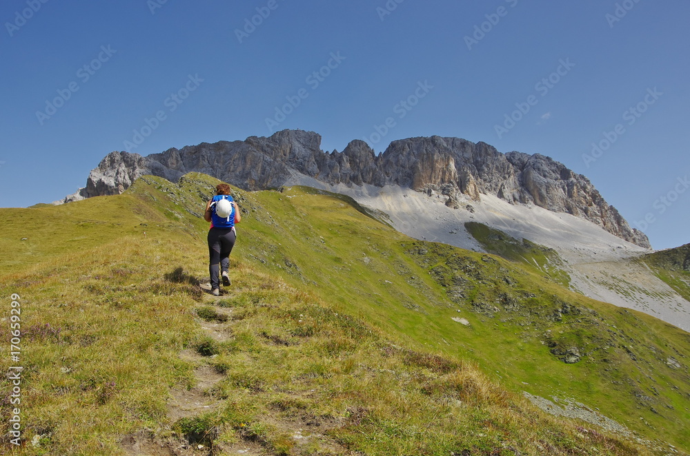 Young woman hiking in the Dolomites