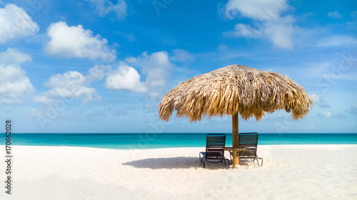 Straw umbrella on Eagle Beach, Aruba on a lovely summer day photo