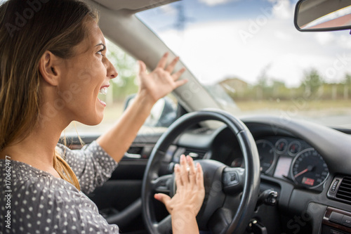 Angry woman honking in the car