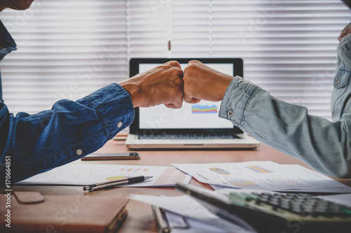 Принти на полотні Business team giving fist bump after complete deal.