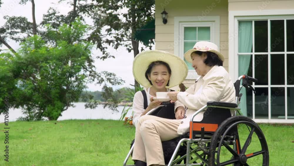 Elderly woman relax in backyard with daughter Elderly woman relax in backyard with daughter