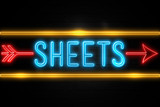 Sheets  - fluorescent Neon Sign on brickwall Front view
