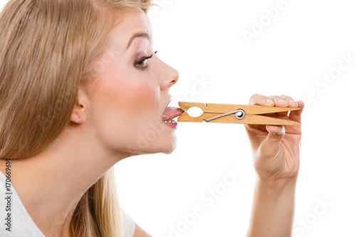 Fotografie Blonde woman having tongue in clothespin