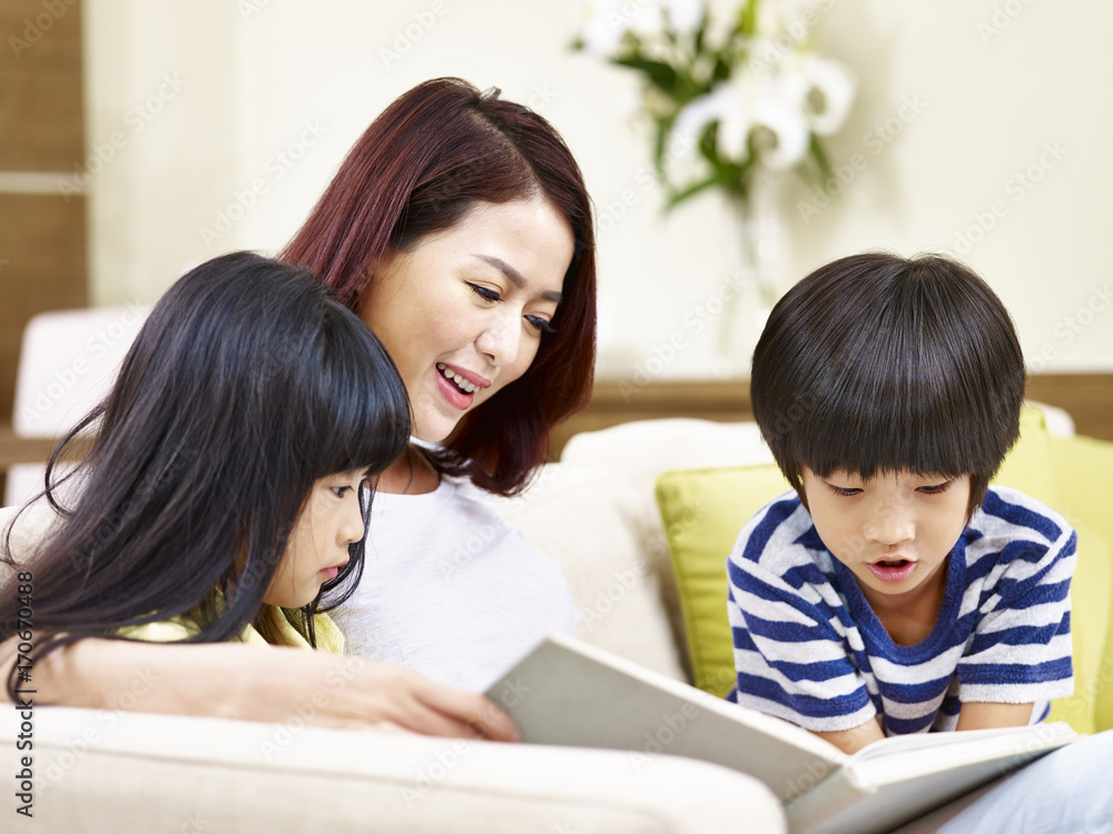 asian mother reading book with two children asian mother reading book with two children