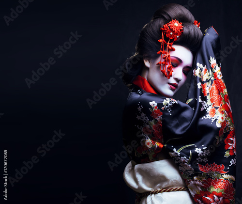 Fotografie, Tablou young pretty geisha in kimono with sakura and decoration
