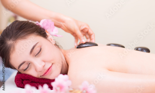 Women is getting Hot stone treatment in Spa
