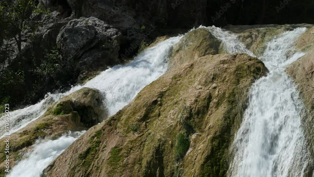 Close up shot of the top part of a cascading waterfalls Close up shot of the top part of a cascading waterfalls