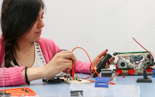 Young electronics student learning about basic PCB connection and robotics photo