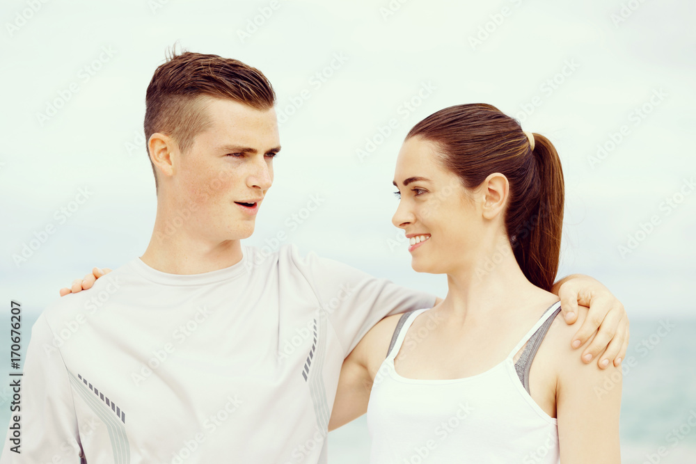 Young couple looking at each other while standing on beach Young couple looking at each other while standing on beach