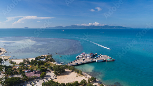 Aerial view of Koh Phangan international port with boats in the clear blue sea © Nopporn