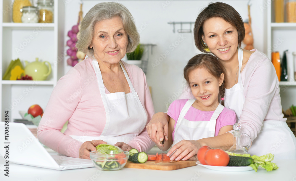 Mother, daughter and grandmother cooking together Mother, daughter and grandmother cooking together