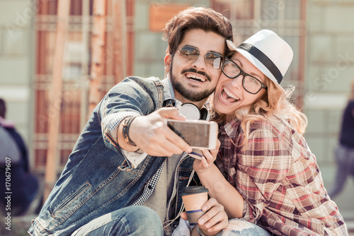 Young couple taking selfie in the city.