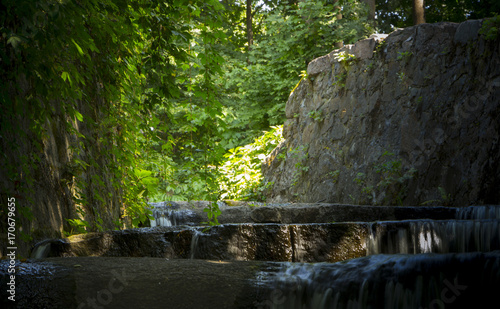 Decorative waterfall with rapids and overflows in the forest