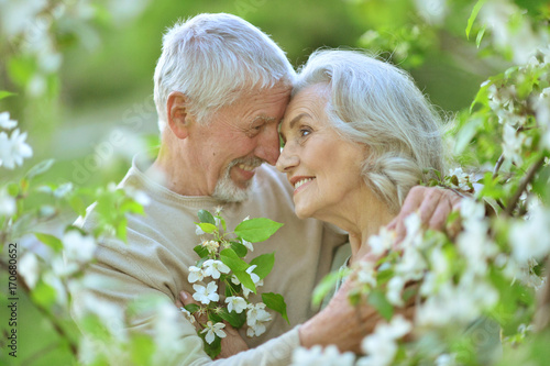 senior couple under blooming tree