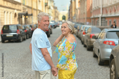 senior couple posing in city