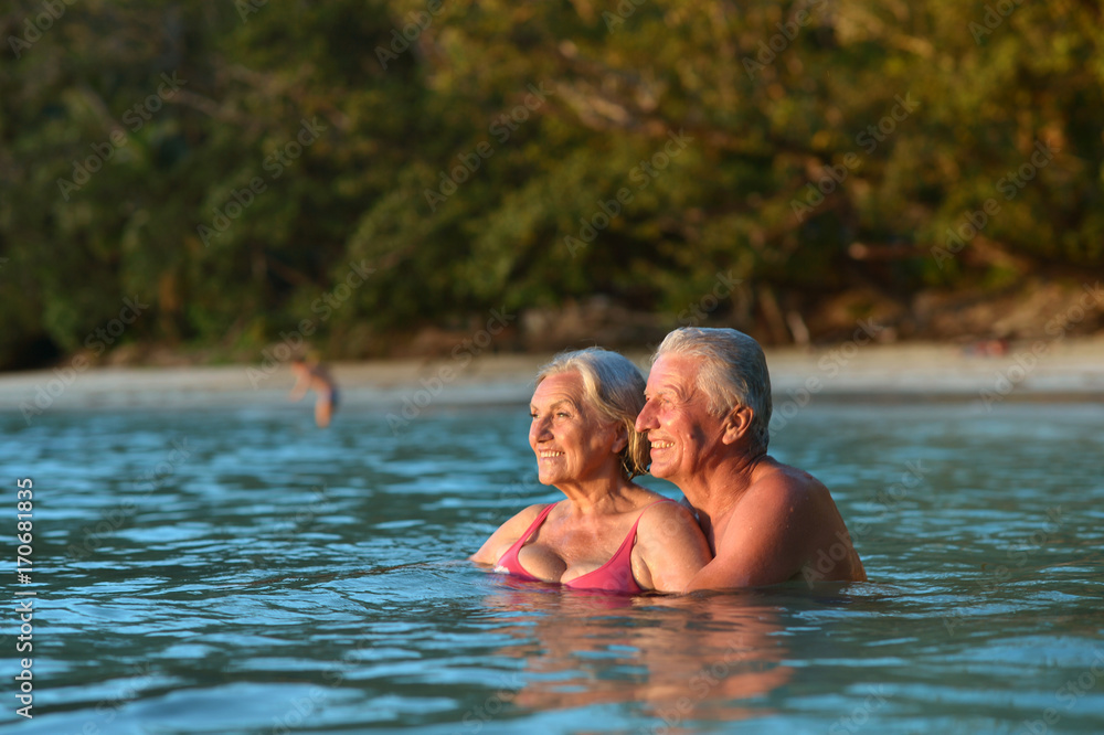 elderly couple in sea water 