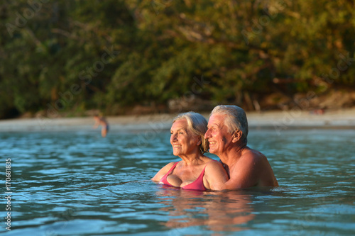 elderly couple in sea water 