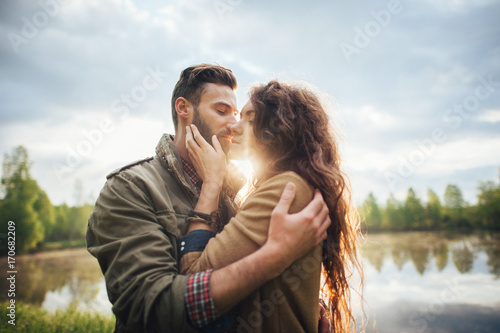 couple standing near beautiful lake