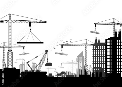 Silhouettes of cranes working on the building