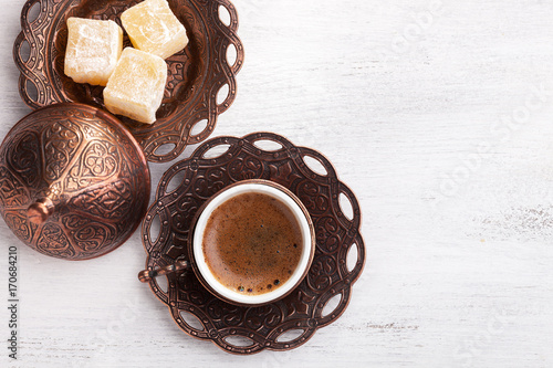 Traditional turkish coffee and turkish delight on white shabby wooden background. flat lay