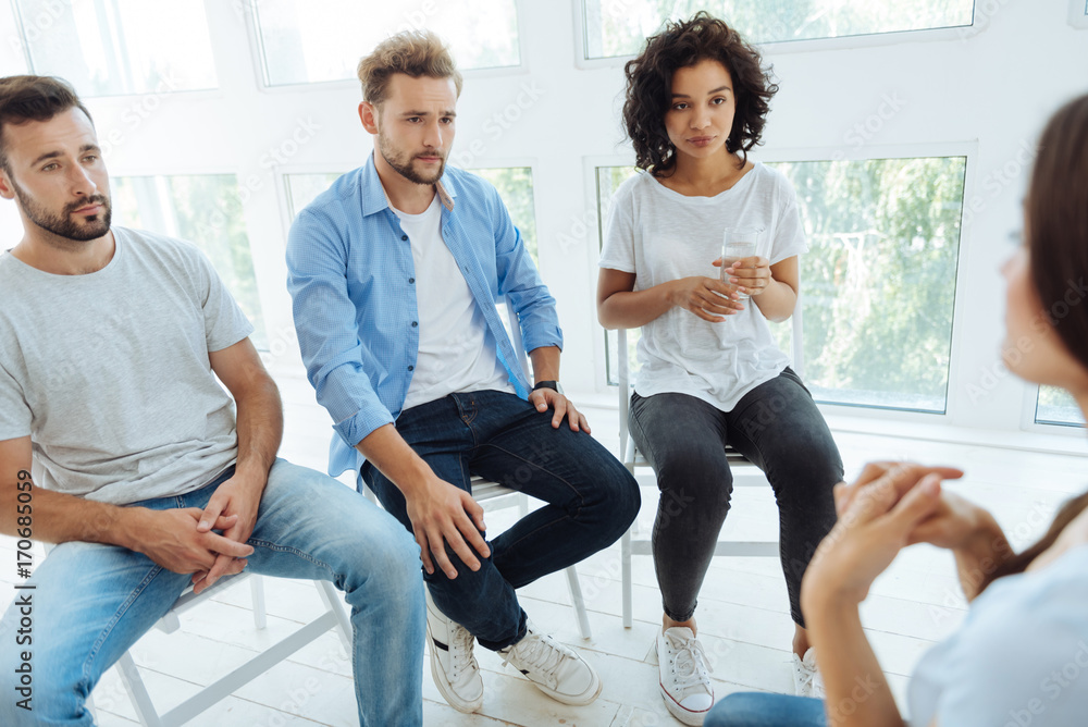 Obraz premium Nice depressed people having a group therapy session
