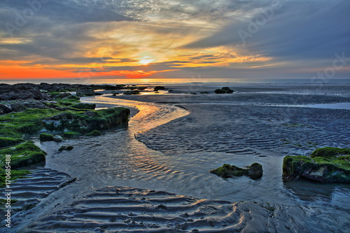 The sunset at Ambleteuse beach near Wimereux, Cote d'Opale, Pas de Calais, Hauts de France, France