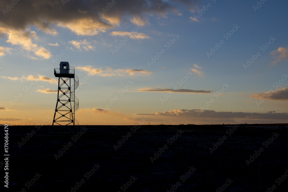 military surveillance tower at sunset