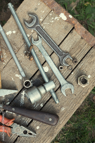 On weathered old wooden surface lie the tools