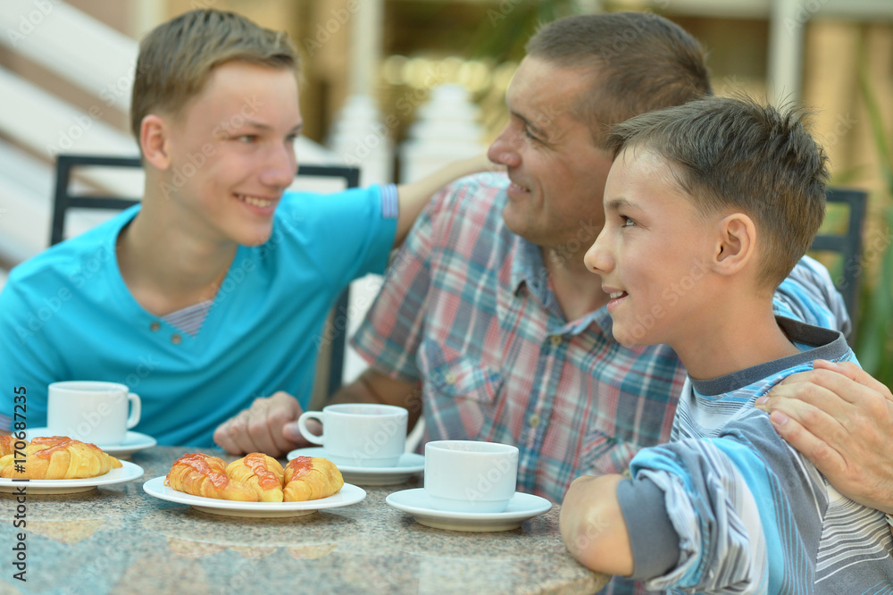 father and sons having breakfast father and sons having breakfast