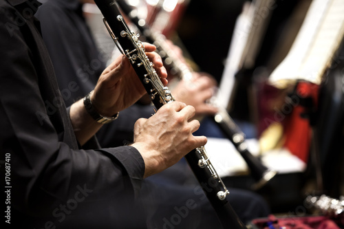 Fototapeta Hands of man playing the clarinet in the orchestra