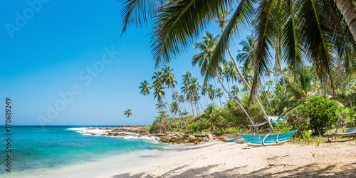 Panoramic view of the beach with traditional wooden fishing boats in Sri Lanka. photo
