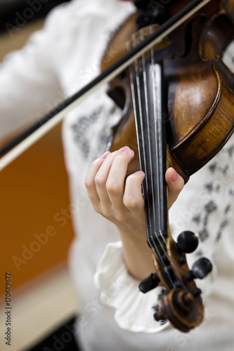  Hand girl playing the violin closeup 